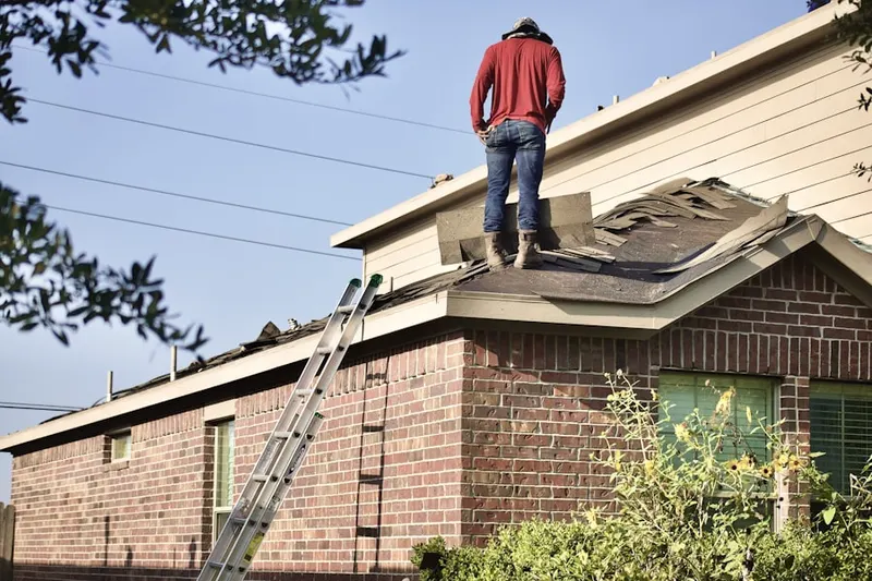 Professional roofer working on a residential roof in Foxridge